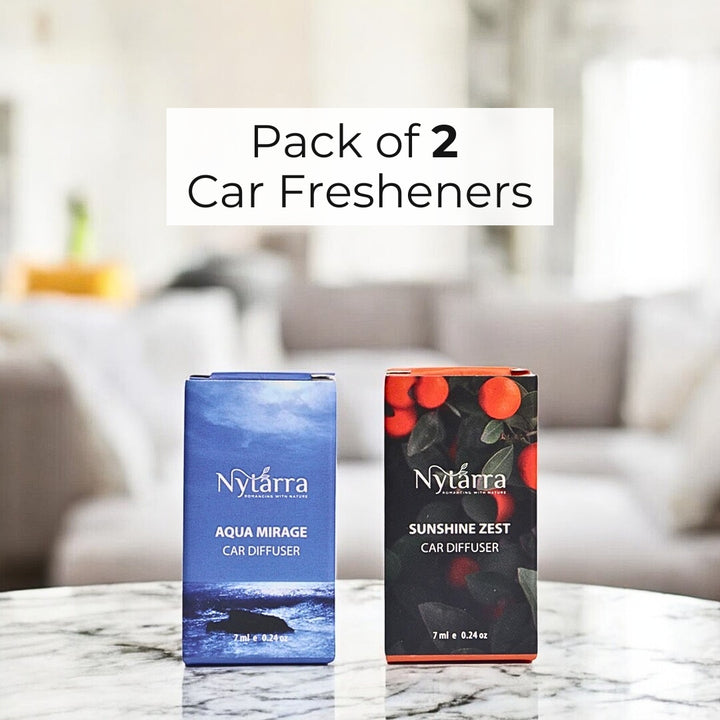 Two Nytarra Naturals car diffuser boxes, Aqua Mirage (blue ocean theme) and Sunshine Zest (citrus theme), placed in soft lighting.