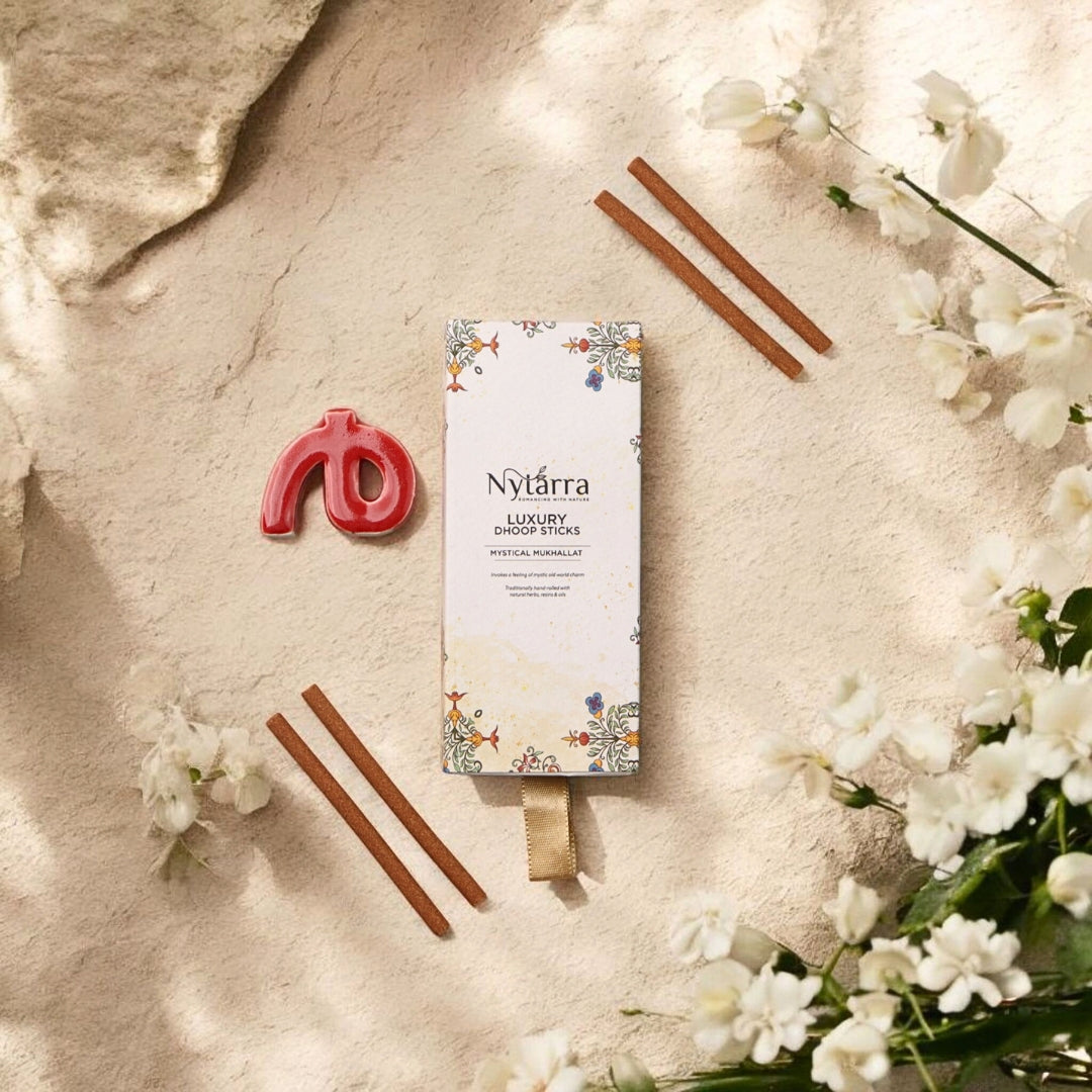 Nytarra Luxury Dhoop Sticks in Mystical Mukhallat scent, with a ceramic holder, placed on a natural textured backdrop.